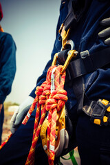 Closeup male worker standing on tank male worker height roof tank knot carabiner rope access safety