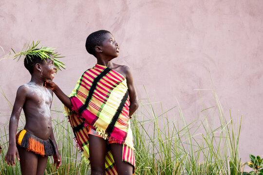Black children standing on sandy ground