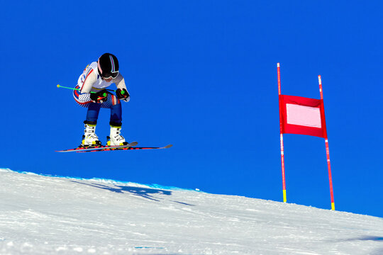 female skier athlete on alpine skiing track, snowy slope on blue sky background, winter sports games - Powered by Adobe
