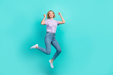 Fototapeta na wymiar Full size photo of satisfied ecstatic woman bob hairdo striped t-shirt flying raising fists win gambling isolated on teal color background