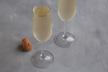 Cold Bubbly Champagne in a Glass on a gray background, side view.