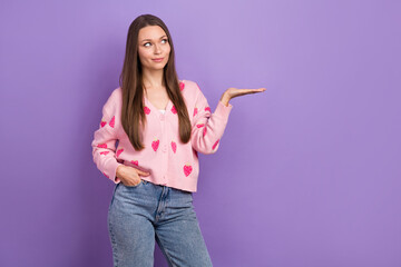 Photo of dreamy funny girl wear berry print cardigan looking holding arm empty space isolated...