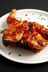 Homemade Spatchcocked Grilled Piri-Piri Chicken with Parsley on a Plate, side view.