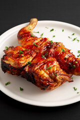 Homemade Spatchcocked Grilled Piri-Piri Chicken with Parsley on a Plate, side view.