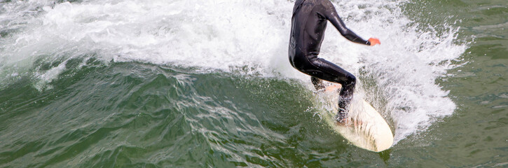 Looking down on a man surfing close up