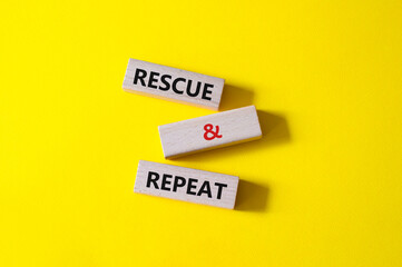 Rescue and Repeat symbol. Wooden blocks with words Rescue and Repeat. Beautiful yellow background. Business and Rescue and Repeat concept. Copy space.