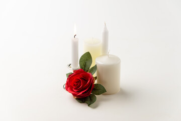 burning candle with other candles on white background metallic lamp steel fire