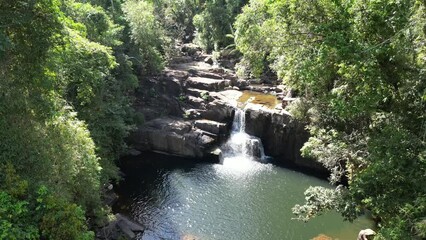 Raising drone footage over Klong Chao waterfall in kood island with forest trees in Thailand