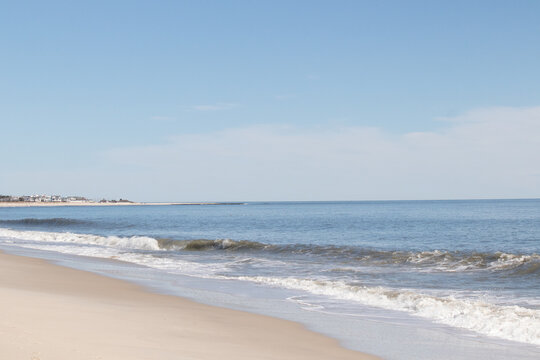 This beautiful beach image was taken at Cape May New Jersey. It shows the waves rippling into the shore and the pretty brown sand. The blue sky with the little bit of cloud coverage adds to this.
