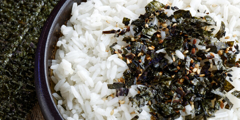 Rice with vegan furikake seasoning with torn nori seaweed on a top. © Fotema