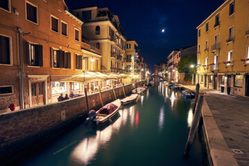 Fototapeta na wymiar Beautiful narrow canal with silky water in Venice