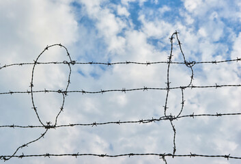 Barb wire fence and blue sky