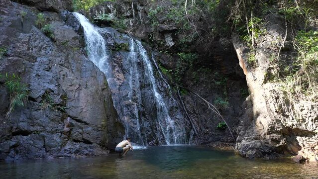 Scenic view of Kai Bae Waterfall surrounded by tropical trees, Koh Kood, Thailand