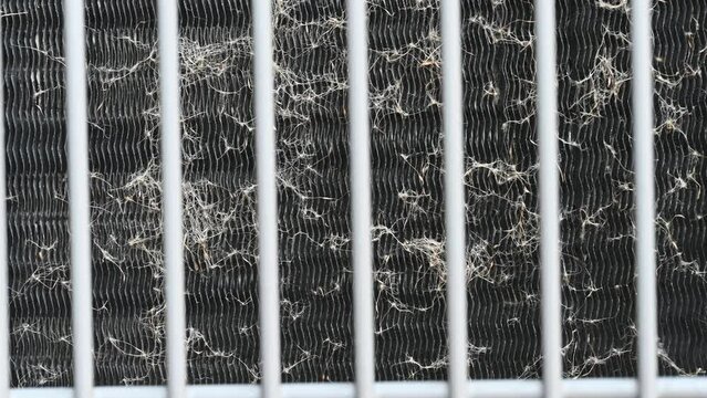 4k, no sound video of washing and cleaning the heat exchanger coils of an air conditioner outside. 