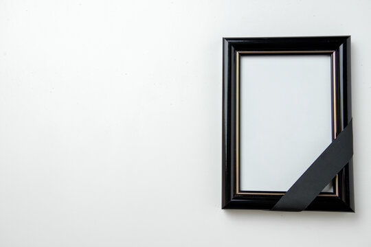 top view empty picture frame of deceased person on a white background funeral death