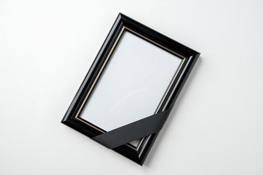 top view empty picture frame of deceased person on the white background funeral death