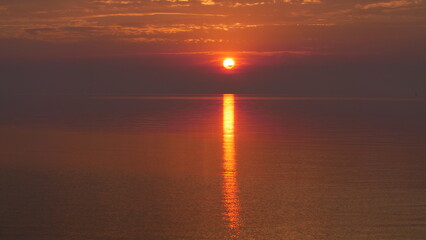 Dramatic Orange Sunrise Over The Water