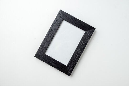 top view empty picture frame on white desk funeral death