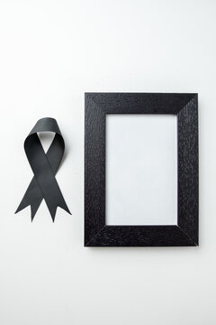 top view picture frame with black bow on a white background funeral death