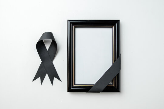 top view picture frame with black bow on white background death funeral