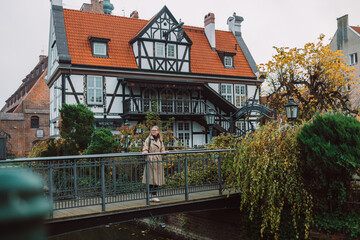 Outdoor smiling lifestyle portrait of pretty young woman having fun in the city in Europe. Gdansk, Poland. High quality photo. High quality photo