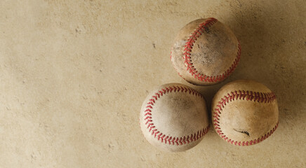 Old used baseball balls on vintage texture background with copy space.