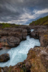 Naklejka na ściany i meble Hraunfossar is a waterfall located in western Iceland, on the Hvitá river,
