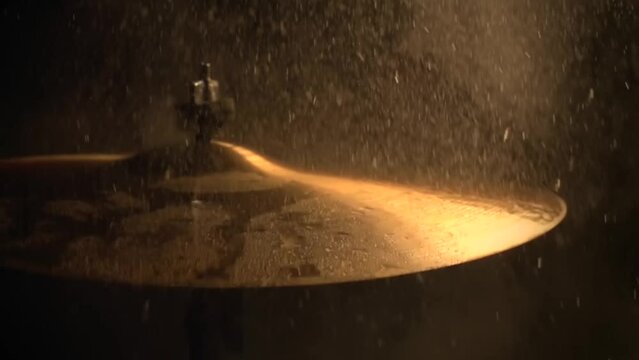 A slow motion of water drops falling on cymbals