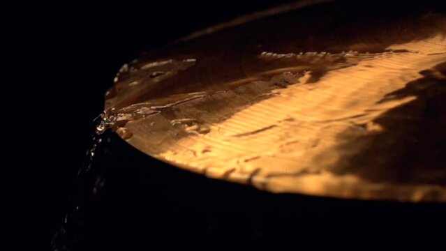 The water flowing on the cymbal of the drums on the black background