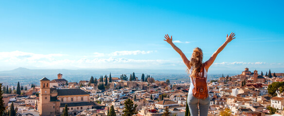 Woman tourist looking at Ancient arabic fortress Alhambra- Granada in Spain - obrazy, fototapety, plakaty