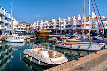 Fototapeta na wymiar Benalmadena marina Spain with boats and yachts restaurants and apartments luxury Costa del Sol destination