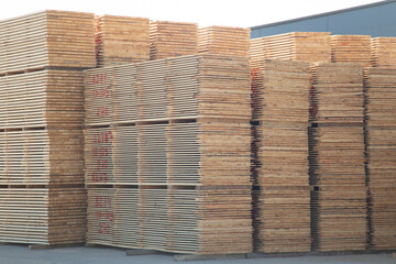 Sawing logs into boards.Timber products warehouse on a specialized site.