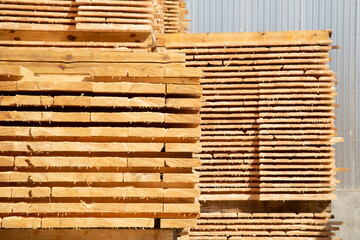 Sawing logs into boards.Timber products warehouse on a specialized site.
