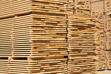 Sawing logs into boards.Timber products warehouse on a specialized site.