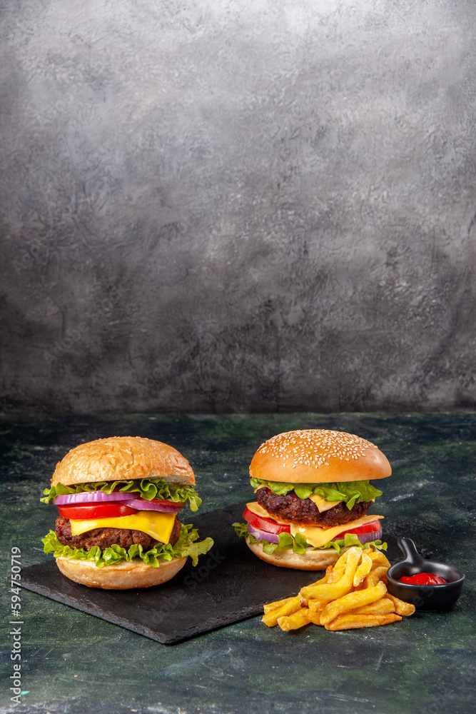 Wall mural Homemade delicious sandwiches on cutting board fries ketchup on dark gray blurred background