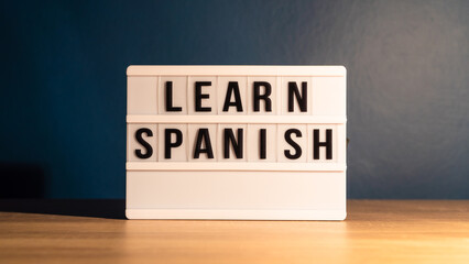 Learning language concept. Learning Spanish word on white letter board. Foreign language course...