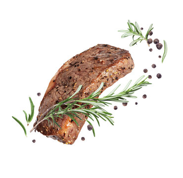 Fried beef steak with rosemary and allspice isolated on a white background