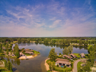 Drone photo of a holiday park with houses around a lake