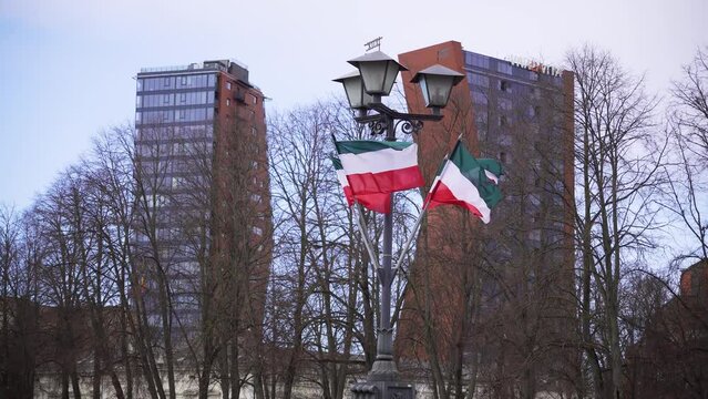 Flag of Hungary fluttering in the wind on the street lantern on a gloomy day