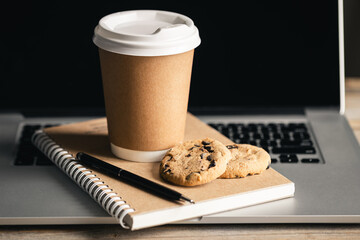 Cardboard Coffee Aroma, Disposable Cup of coffee, chocolate cookies and recycled notebook on...