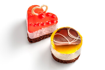 Various cakes with fruit jelly chocolate decoration. Exquisite Fresh delicious mousse dessert on white isolated background with shadow.