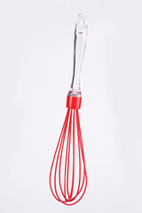 plastic whisk isolated on white background. Cooking egg mixer mixer with wooden handle.