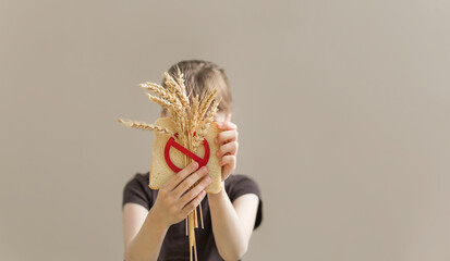 Girl holding bread and crossed spikelet. gluten free concept. Banner international day of celiac.