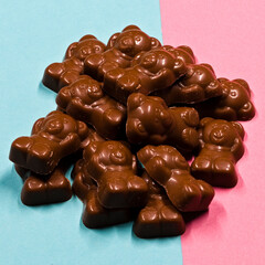 A pile of chocolate bears laid out on pink and blue card. A good mage for a confectionery store.