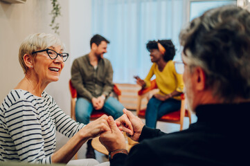 Senior people talking about their mental health on a group therapy session