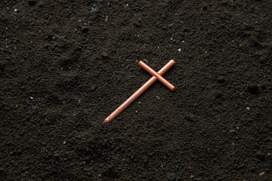 front view of cross on soil grim reaper funeral death evil