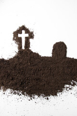 top view cross shape with dark soil on white surface death grim reaper