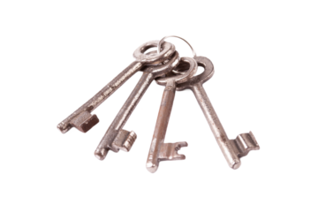 A simple set of 4 old worn metal keys on one keychain, object isolated on white, cut out, nobody. Prison jail cell keys key chain, safety, security measures, keys in technology abstract concept