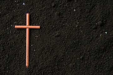 top view of cross on soil death grim reaper