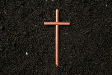 top view of cross on soil grim reaper funeral